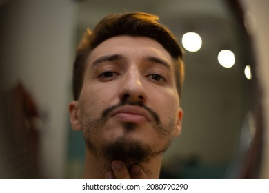 The Guy With The Rare Beard Looks In The Bathroom Mirror In A Touched Way