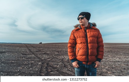 the guy in the red jacket in the field