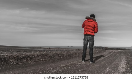 the guy in the red jacket in the field