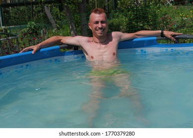 A Guy With A Red Mohawk Swims In The Pool.