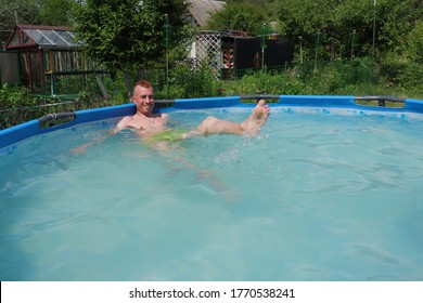 A Guy With A Red Mohawk Swims In The Pool.