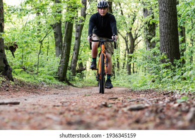 the guy rides in the forest, along the forest paths - Powered by Shutterstock