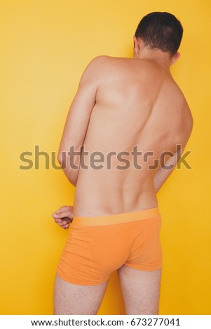 Similar – young guy with a tattoo on his back in colored shorts