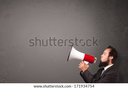 Guy shouting into megaphone on copy space background