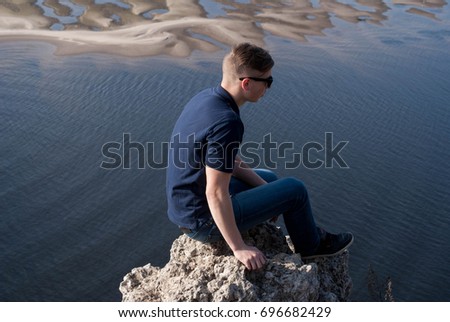 The guy sits on the precipice