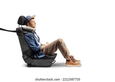 Guy Sitting In A Carseat With A Seatbelt And Pillow For His Neck Isolated On White Background