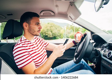 A Guy Is Sitting In His Car While Holding Coffee In One Hand And Looking Interested In His Mobile Phone, Near Miss