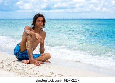 The guy sitting on the beach