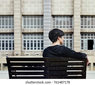 Guy sitting on a bench alone