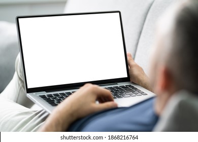 Guy Sitting On Sofa Using Laptop In Living Room