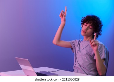 Guy Sitting At The Table Gaming Laptop Violet Background