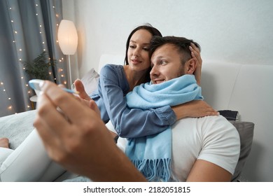 Guy with slight indisposition in bed in company of his girlfriend - Shutterstock ID 2182051815