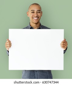 A guy is smiling with placard