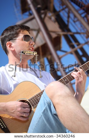 Similar – Young musician enjoying guitar on sunny day