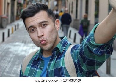 Guy taking a selfie with ducks lips 