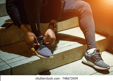 A Guy Tying Running Shoe, Preparing for Running in Dawn - Powered by Shutterstock