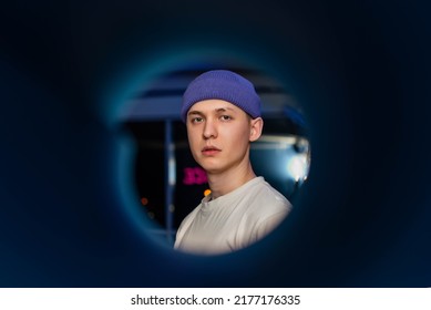 Guy In A Violet Hat In The Camera Lens. Shaved Eyebrows