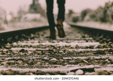 Guy walking in the train tracks