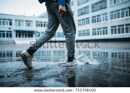 the guy walks through the puddle Stock fotó © 