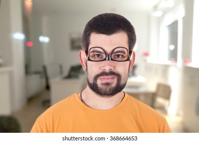 Guy wearing glasses upside down