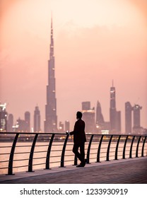 Guy Wearing A Suit Looking At The Amazing Modern Skyline View Of Dubai. Luxury Travel Destination Inspiration. 