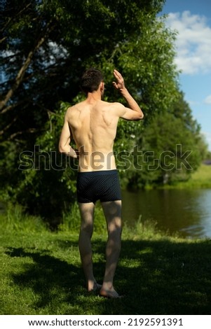 Similar – sports guy in his underwear looking at the river