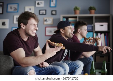 Guys Enjoying Junk Food And Watching Tv 