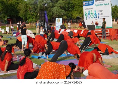 Gwalior, India - June 21, 2022: Group of People performing surya namaskar exercise, concept of international yoga day