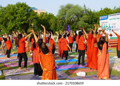 Gwalior, India - June 21, 2022: Group of People performing surya namaskar exercise, concept of international yoga day