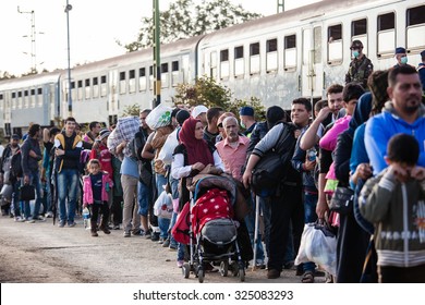 GYEKENYES- OCTOBER 5 : War refugees at the Gyekenyes Zakany Railway Station on 5 October 2015 in Gyekenyes, Hungary. Refugees are arriving constantly to Hungary on the way to Germany.