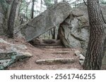 Gyeongju-si, Gyeongsangbuk-do, South Korea - April 6, 2024: Spring view of a giant fallen rock and stone Iljumun Gate with pine trees at Yongmunsa Temple of Maseoksan Mt.
