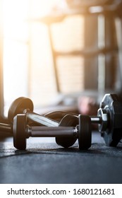 Gym Background With Black Dumbbell On Dark Floor In Fitness