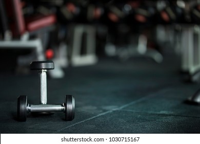 Gym Background With Dumbbells On Dark Floor With Free Copy Space