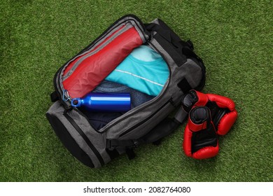 Gym Bag And Sports Equipment On Green Grass, Flat Lay