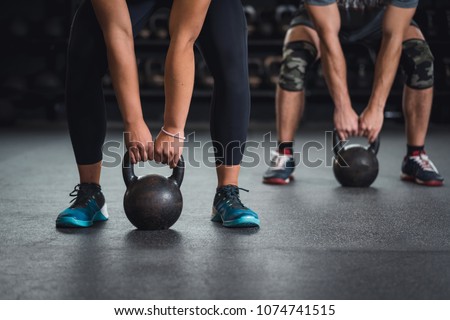 Gym class doing exercise with kettle bells
