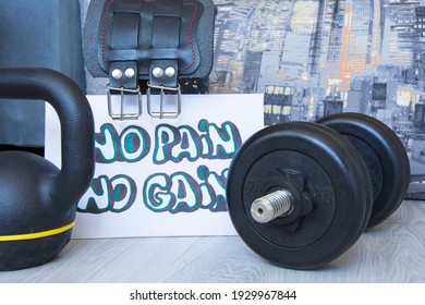 Gym dumbbell, belts, kettlebell with motivational poster Train hard for active workouts at home. Home workouts, healthy lifestyle - Powered by Shutterstock