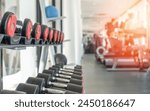 Gym dumbbell blur background fitness center, workout personal weight training studio, health club with blurry sports exercise equipment for bodybuilding and power strength class