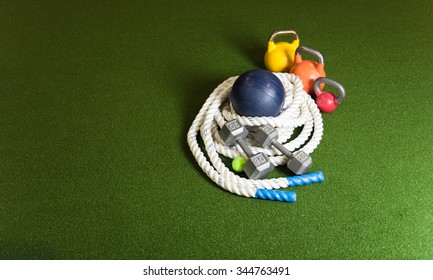 Gym Equipment For Bootcamp  Classes.  Kettle Bells, Rope, Dumbbells, Medicine Balls On Green Turf