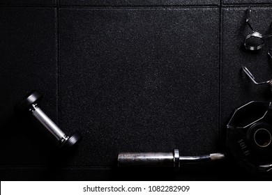 Gym Equipment On Empty Dark Floor Background