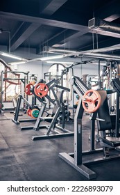 Gym, equipment and weights of fitness background for exercise, training or heavy workout for strength building and wellness. Empty health club of interior space and machines or tools for exercising - Shutterstock ID 2226893079