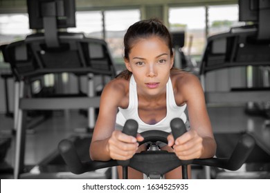 Gym Fitness Class Fit Woman Riding Spin Bike Doing Hiit Exercise Cycling Doing Cardio Workout Biking On Indoors Gym Bike. Girl Cyclist Working Out Interval Training On Bicycle. Weight Loss.