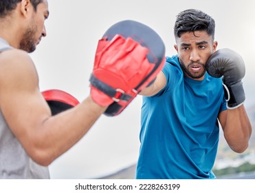 Gym, fitness and man boxing with coach, coaching and motivation for health, training and self defense. Workout, exercise and wellness commitment, strong athlete boxer outdoor in urban city or Brazil - Powered by Shutterstock