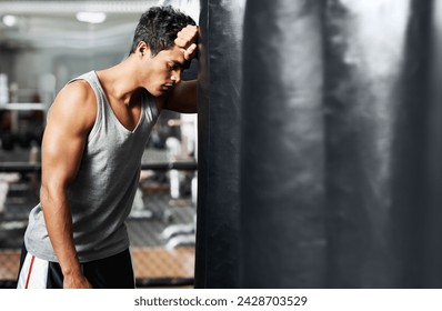 Gym, fitness and tired with man and punching bag, low energy and performance mistake or disaster. Sports, fatigue or boxer exhausted by intense body workout, challenge or fighting practice burnout - Powered by Shutterstock