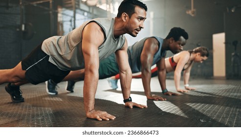 Gym, group fitness and push up exercise for power, sports challenge and muscle on ground. Serious asian man, bodybuilder and performance training on floor with friends, workout class or strong people - Powered by Shutterstock