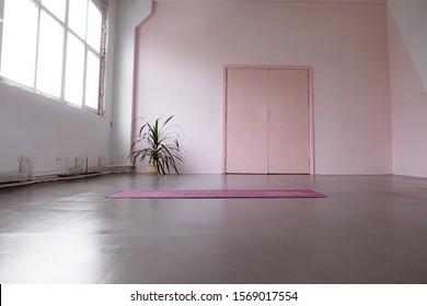 Gym Interior With Pink Yoga Mat, Big Windows, No People. Copy Space