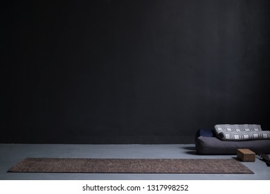 Gym Interior With Yoga Mat And Props. No People. Copy Space On Black Wall At Studio