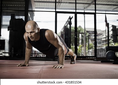 Gym Man Push-up Strength Pushup Exercise With Dumbbell In A Crossfit Workout