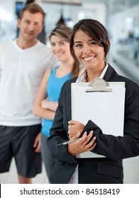 Gym Manager Showing The Facilities To A Couple