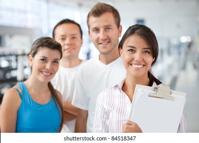 Gym Manager Showing The Facilities To A Group Of People