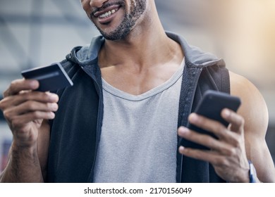 A Gym Membership Is Worth The Investment For Me. Closeup Shot Of A Muscular Young Man Using A Cellphone And Credit Card In A Gym.